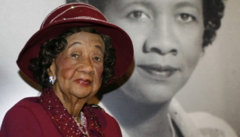 ** HOLD FOR RELEASE UNTIL 12:01 a.m. EDT TUESDAY JUNE 15, 2010 **  FILE - In this Feb. 14, 2008, file photo Dorothy Irene Height, longtime president of the National Council of Negro Women the leading female voice of the 1960s civil rights movement, poses in front of her portrait inside the "Freedom's Sisters" exhibition at the Cincinnati Museum Center, in Cincinnati, wearing her signature-style Bene' hat. Most of the hats worn by Height were created by Washington milliner Vanilla Beane, and became known far and wide as a statement of her dignity and grace.  (AP Photo/David Kohl, File)